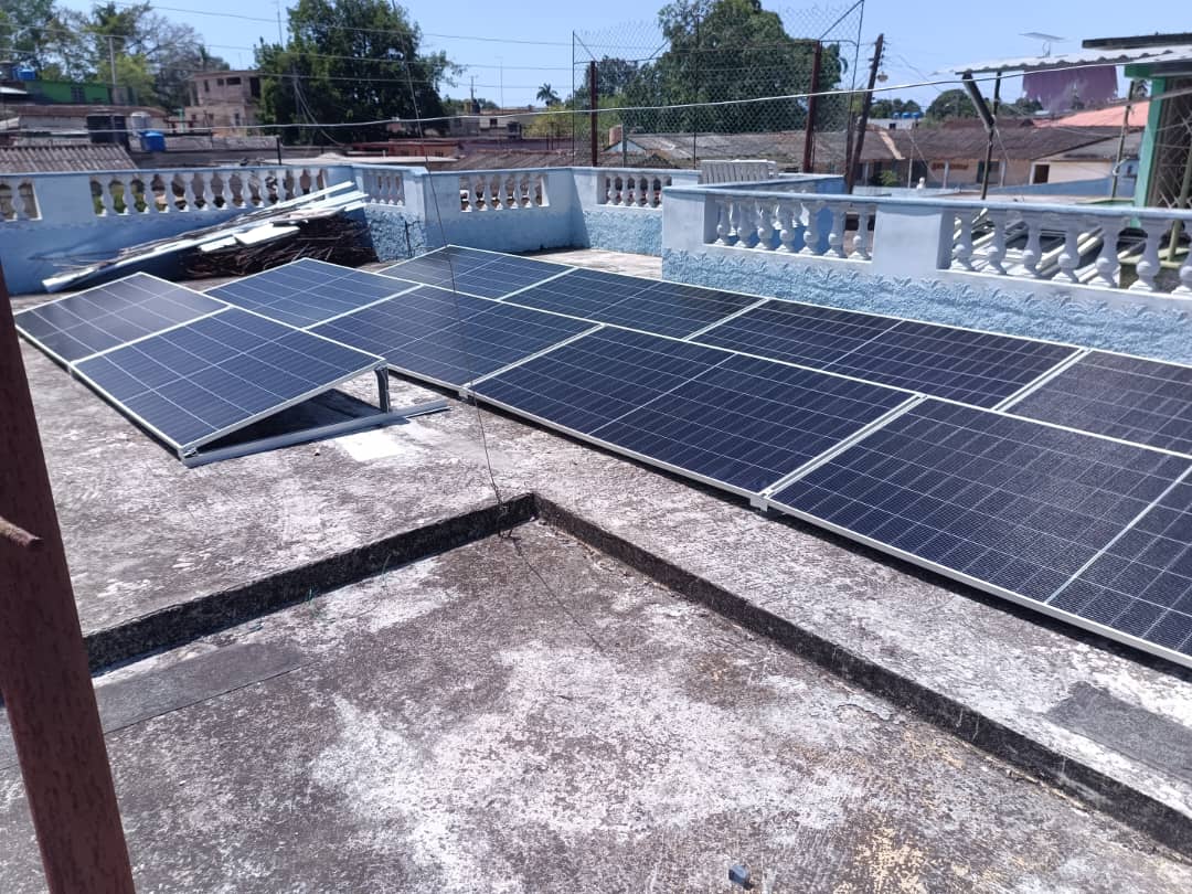 Solar panels mounted on a concrete residential rooftop in Cuba